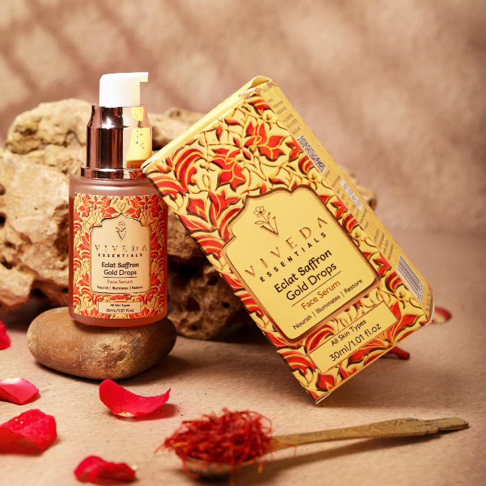 Viveda Edat Saffron Gold Drops face serum with packaging on a textured background
