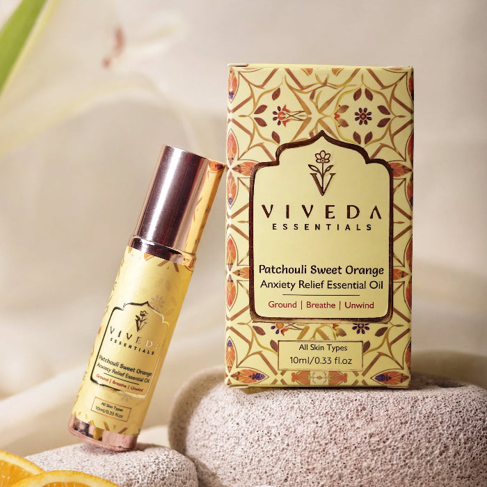 Viveda Essentials Patchouli Sweet Orange Anxiety Relief Essential Oil bottle and box on a neutral background